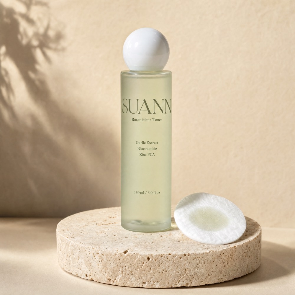 SUANN Botaniclear Toner bottle on a travertine pedestal